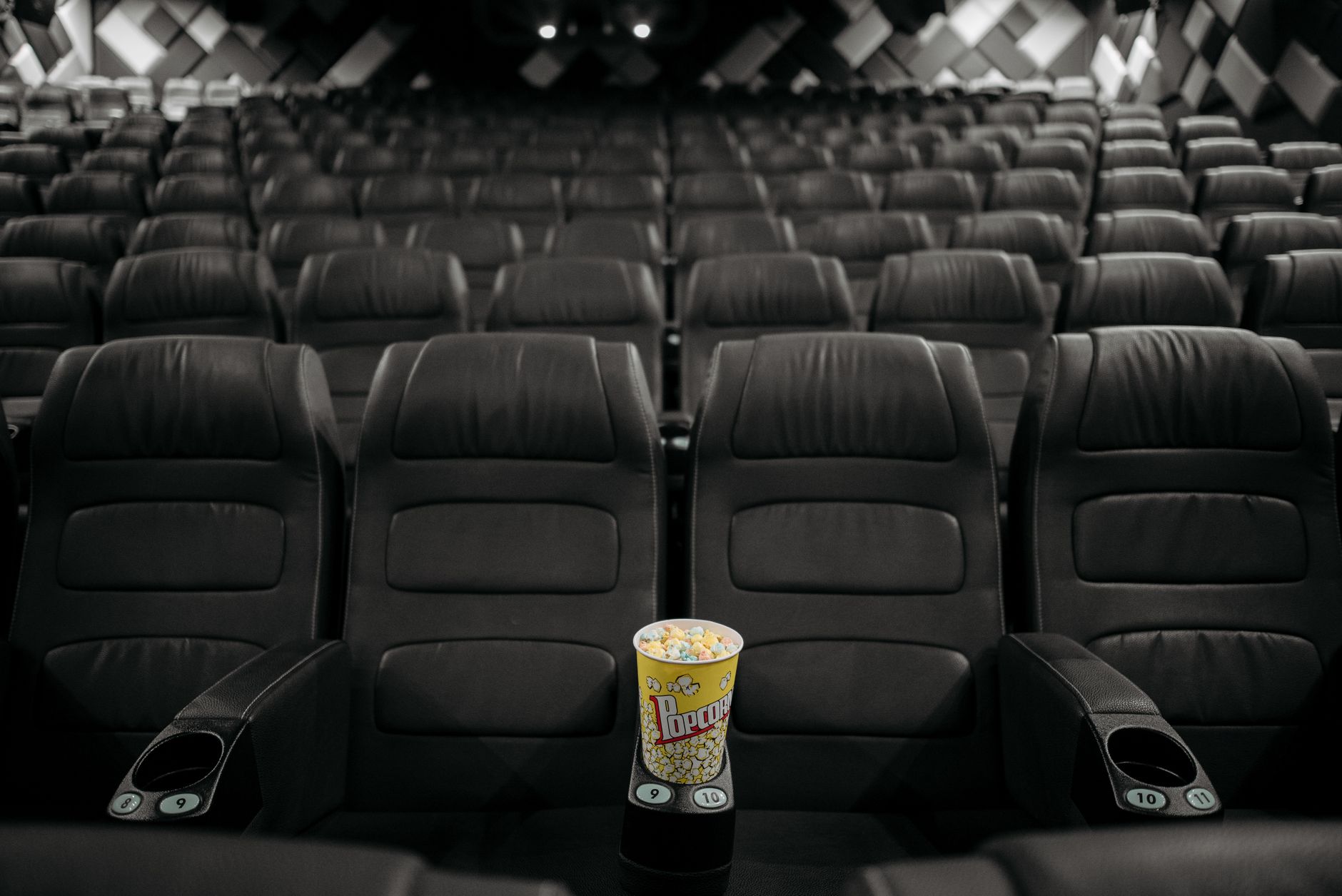 cinema theater hall dark seats with screen glow