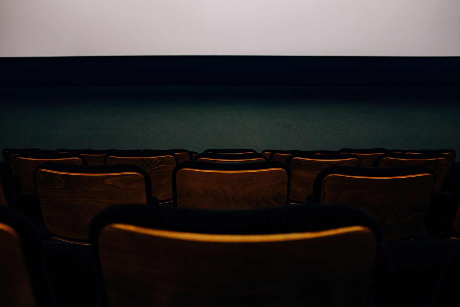 cinema theater hall dark seats with screen glow