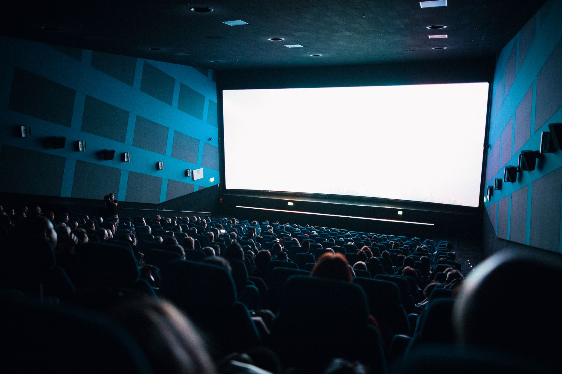 cinema theater hall dark seats with screen glow