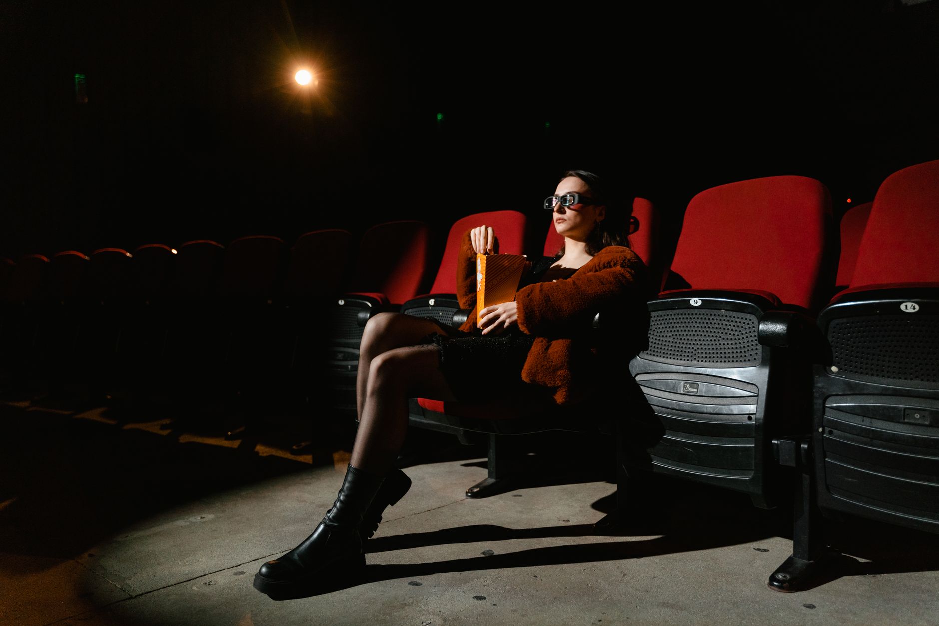 person watching animated movie alone dark room