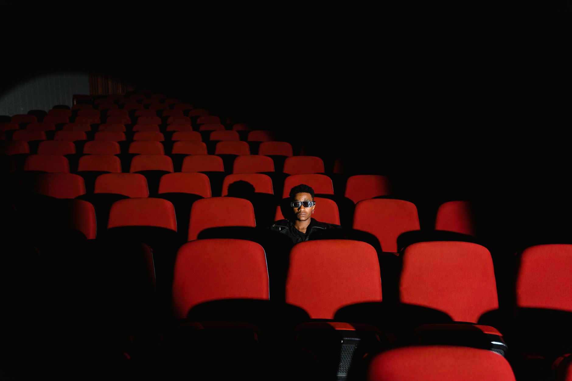 person watching drama movie alone dark room