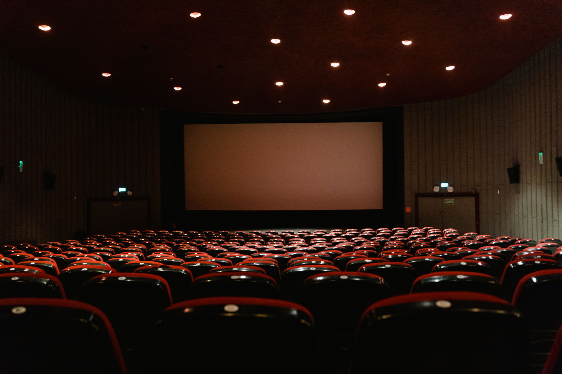 cinema theater hall dark seats with screen glow