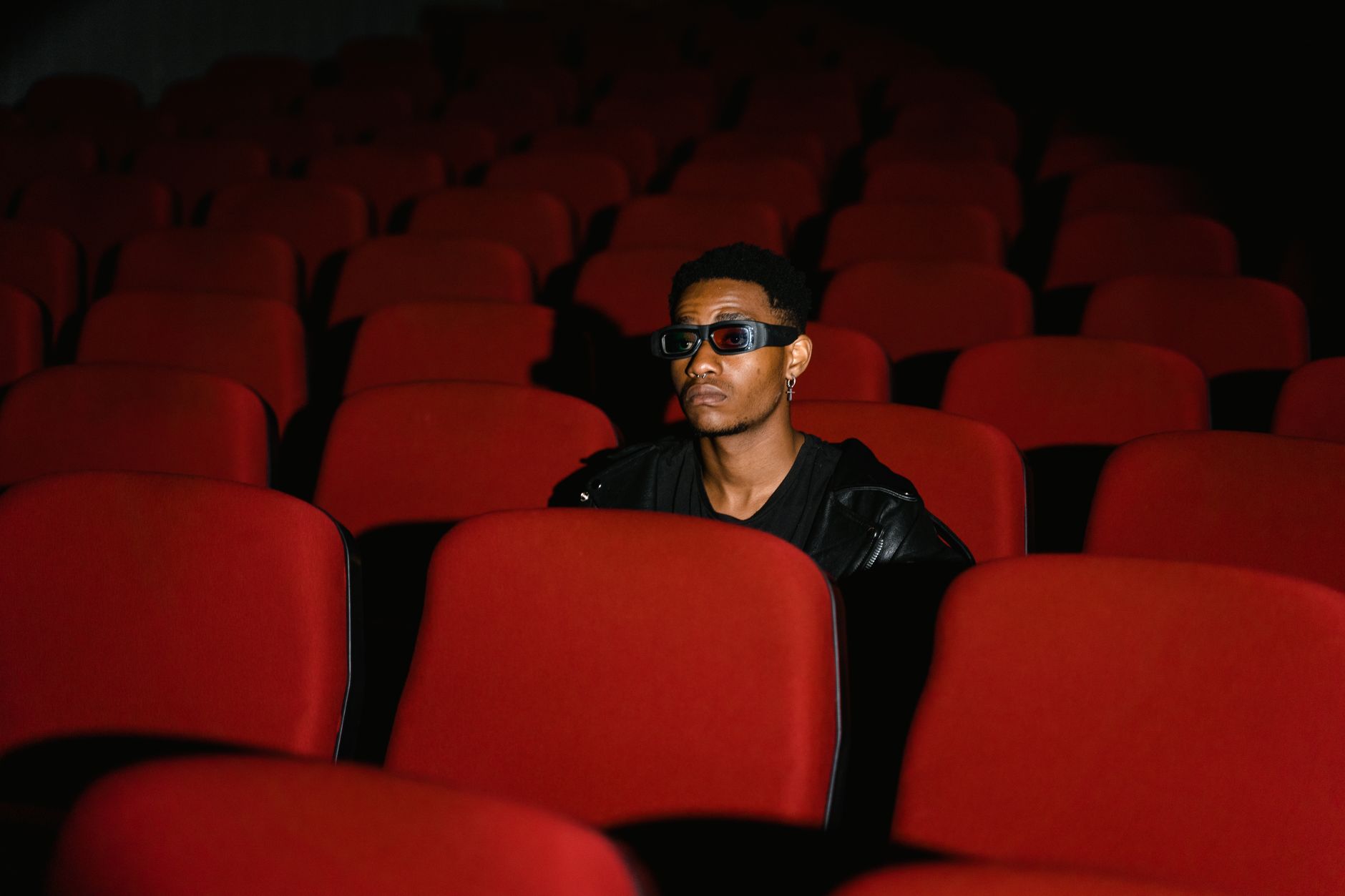 person watching thriller movie alone dark room