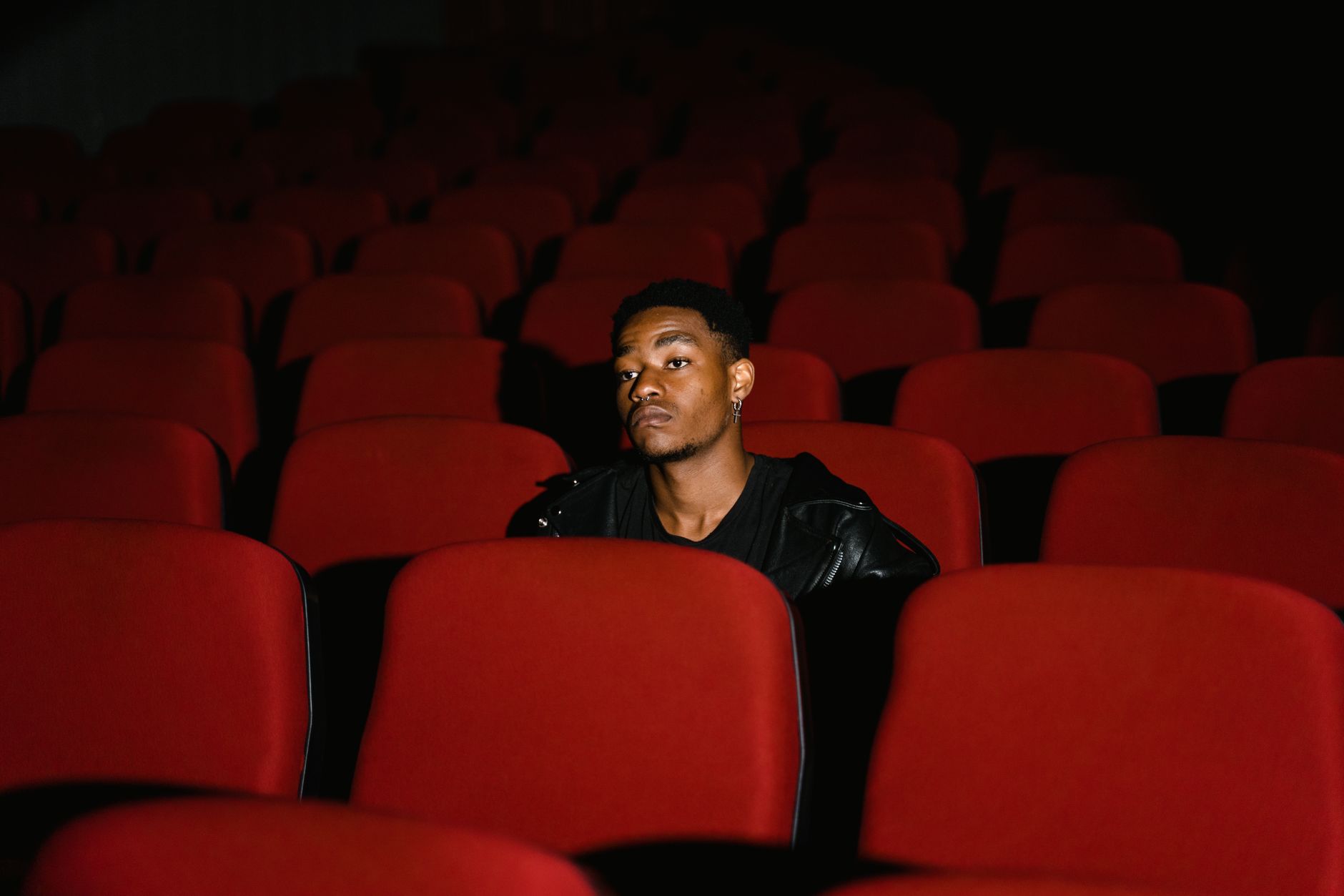 person watching thriller movie alone dark room