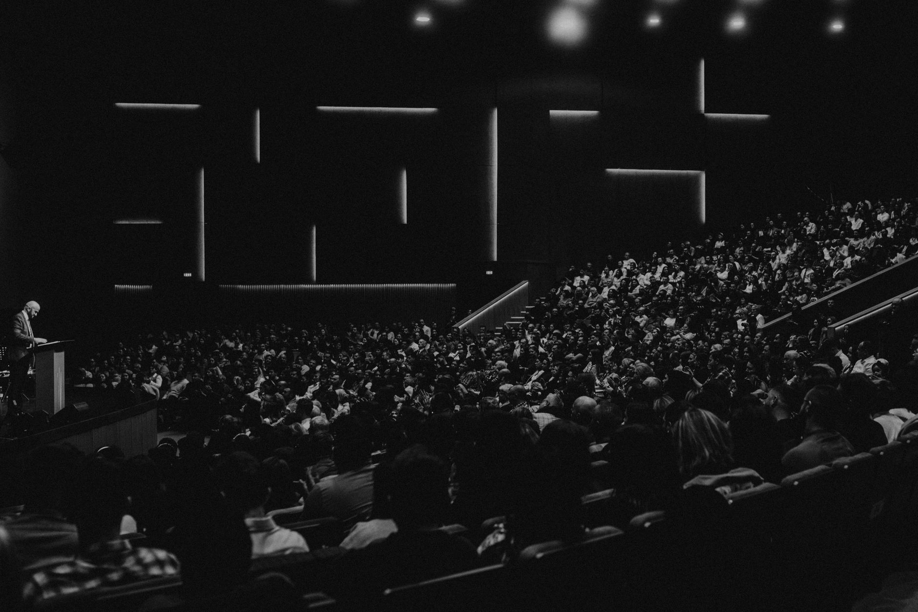 cleric delivering humorous lecture to large audience