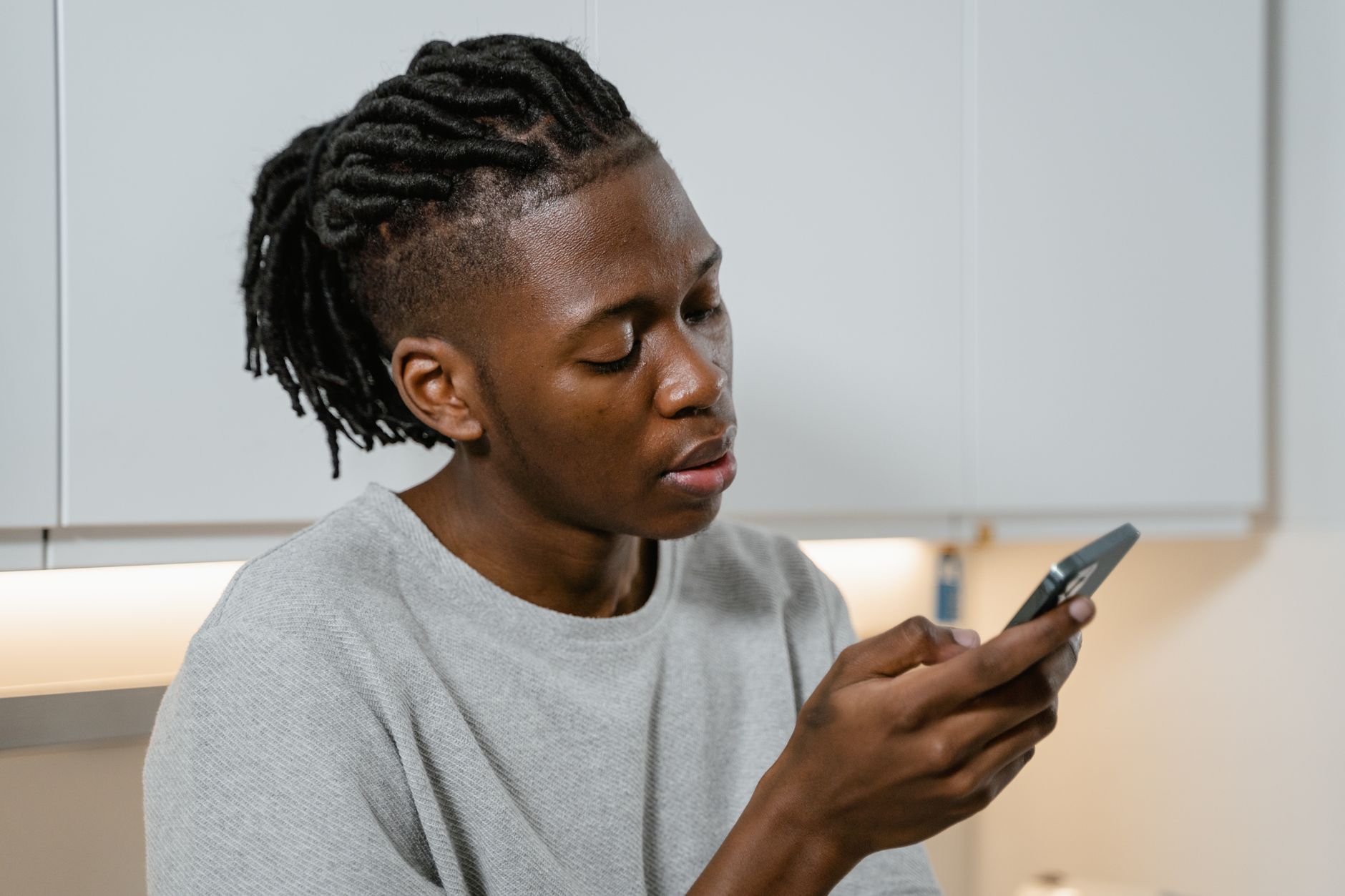 person holding smartphone checking signal bars indoors