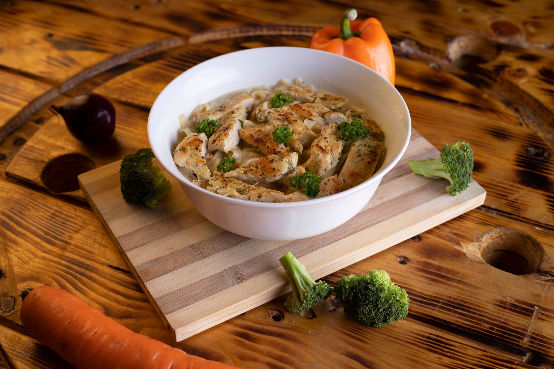 steaming boiled vegetables and chicken breast in bowl