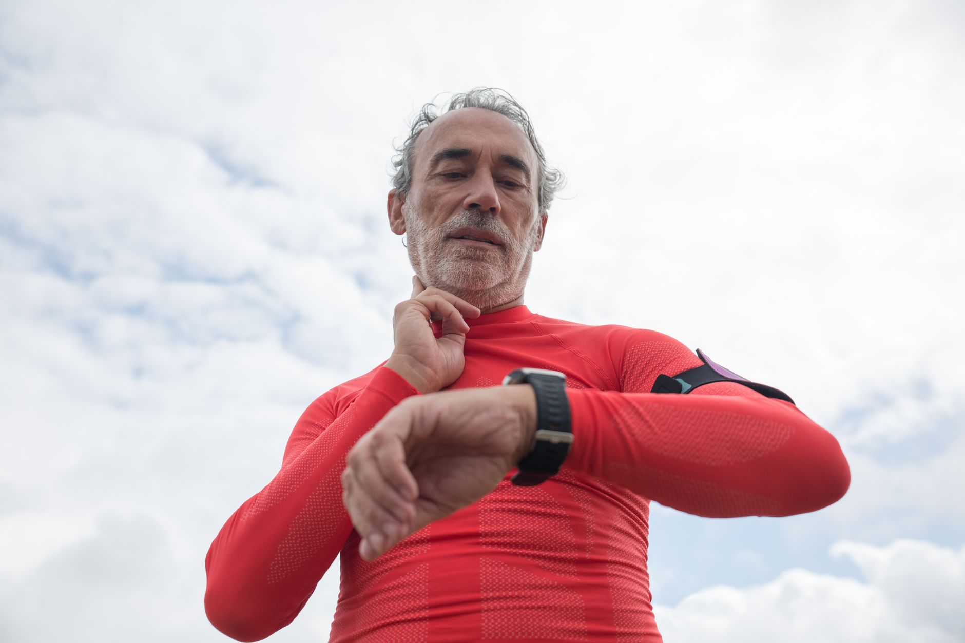 runner checking smartwatch data outdoor park