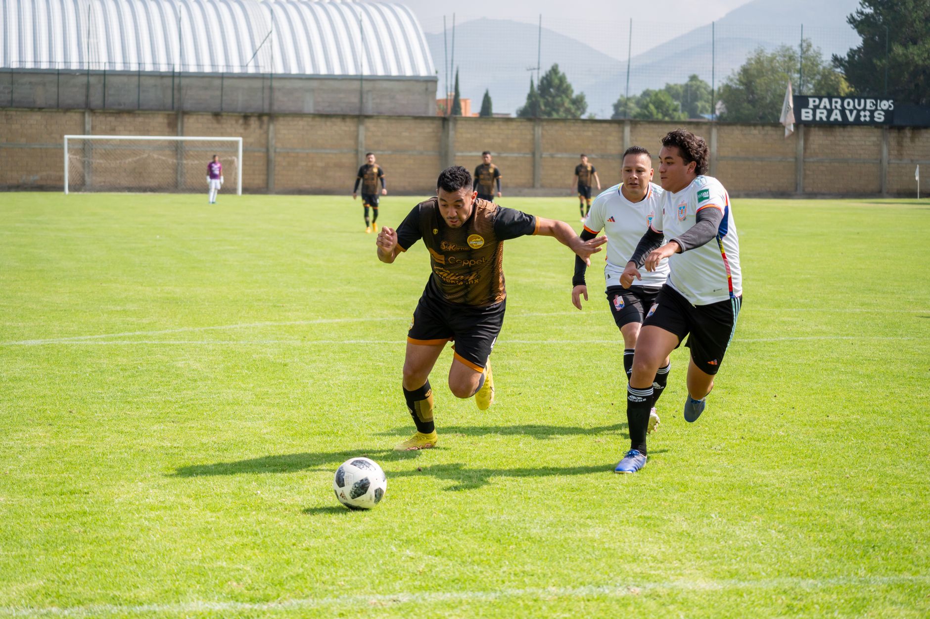 Mexican football players competing for ball on field