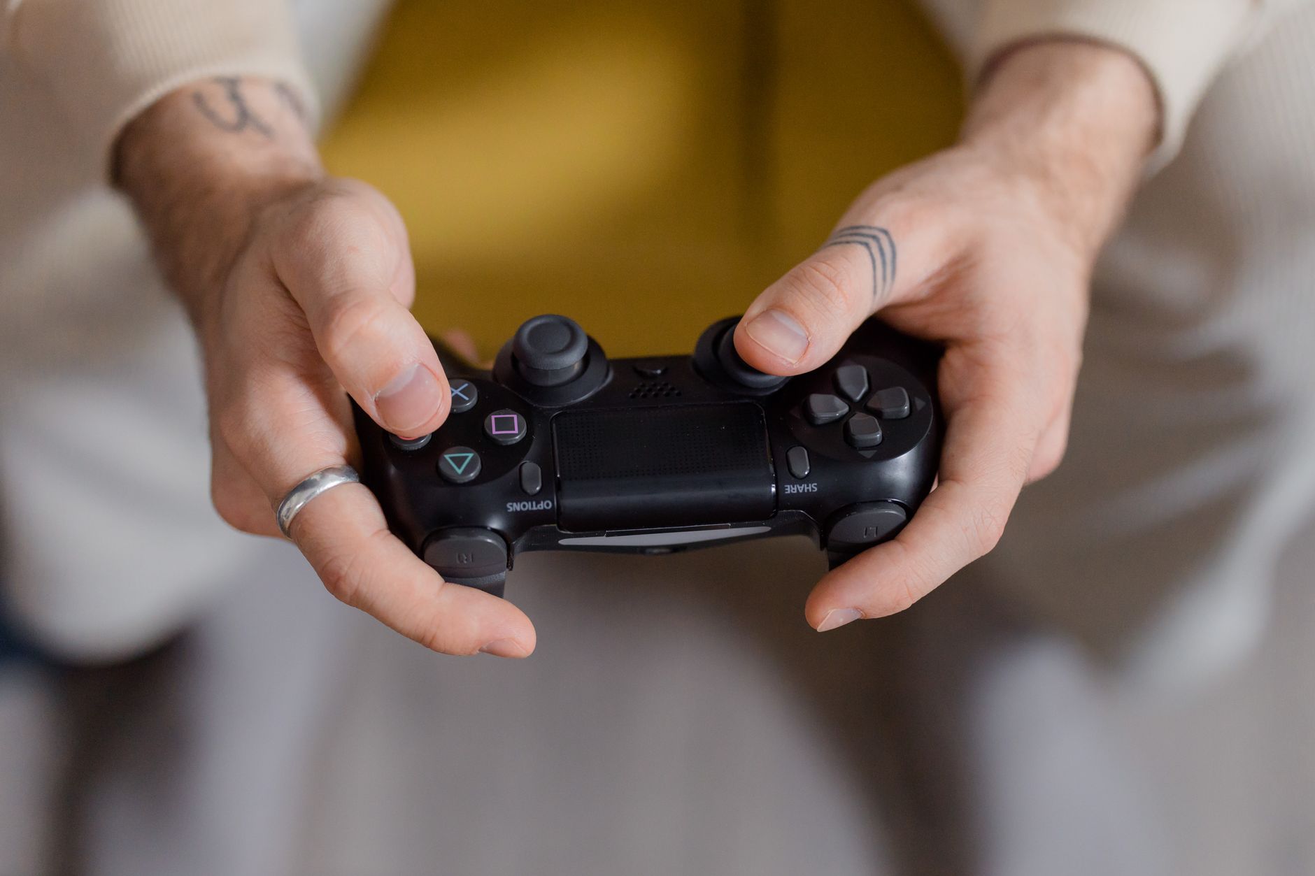 person hand holding android phone playing game