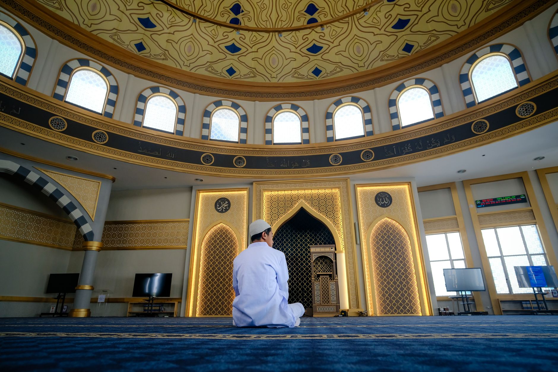 muslim man praying at mosque at sunrise