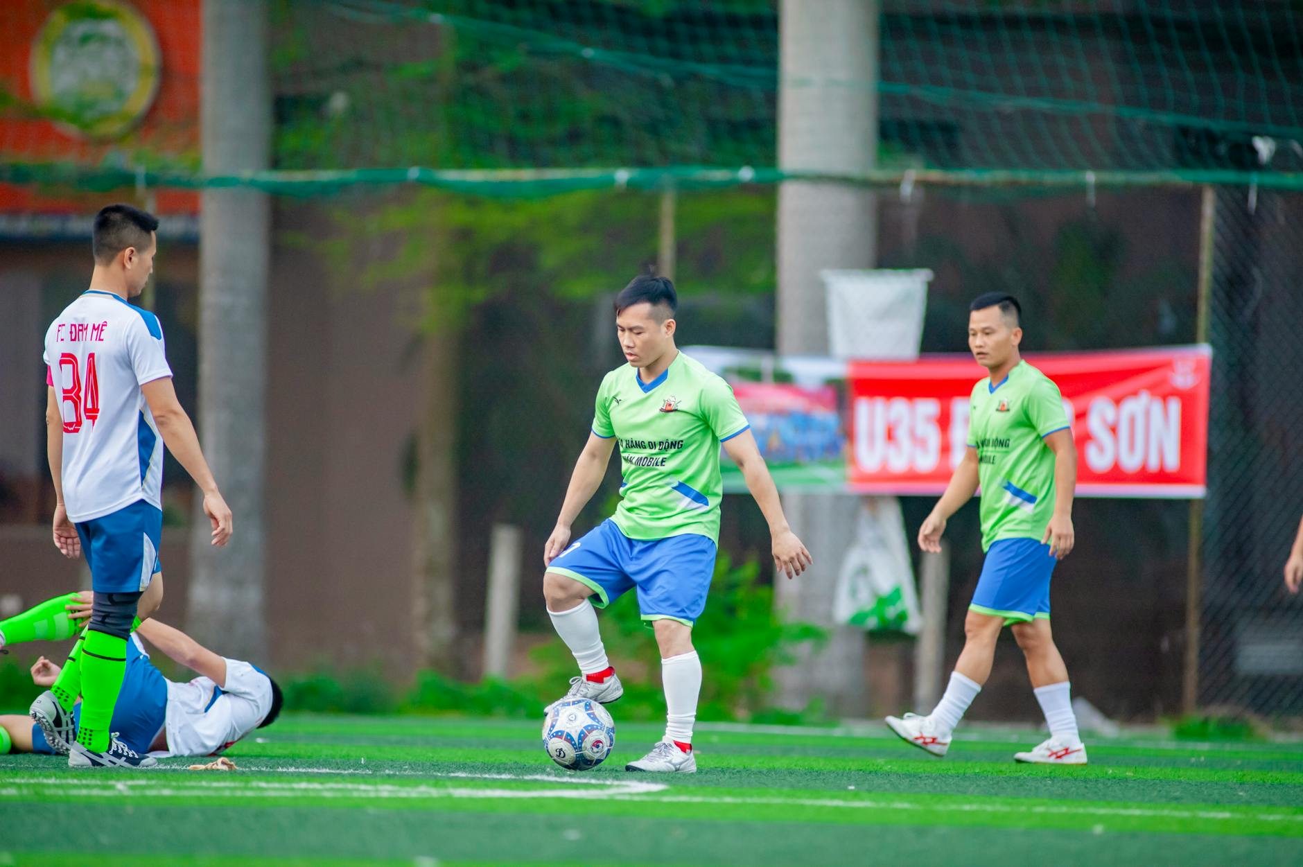 Indonesian football players competing for ball on field