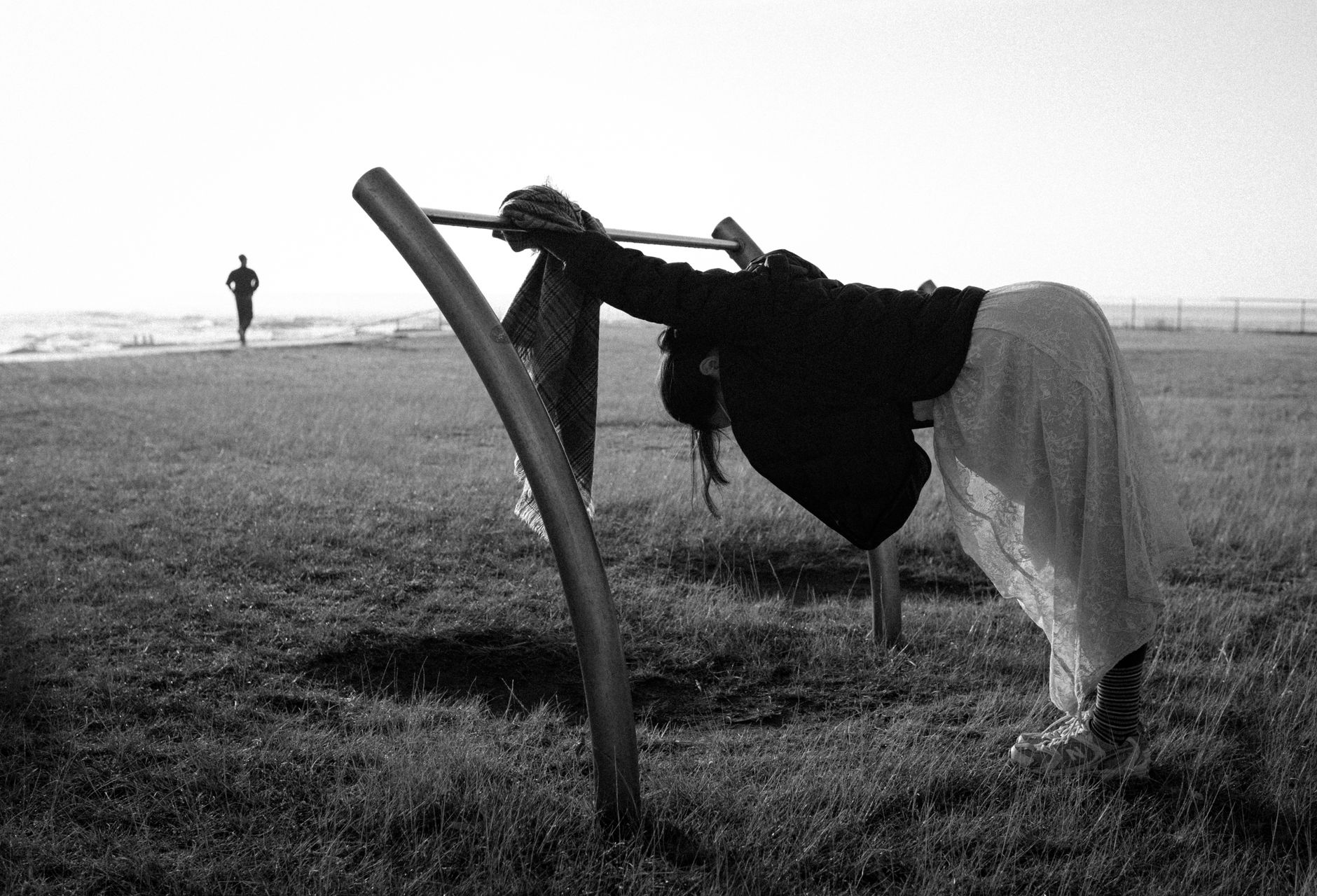 woman runner stretching before morning run in park