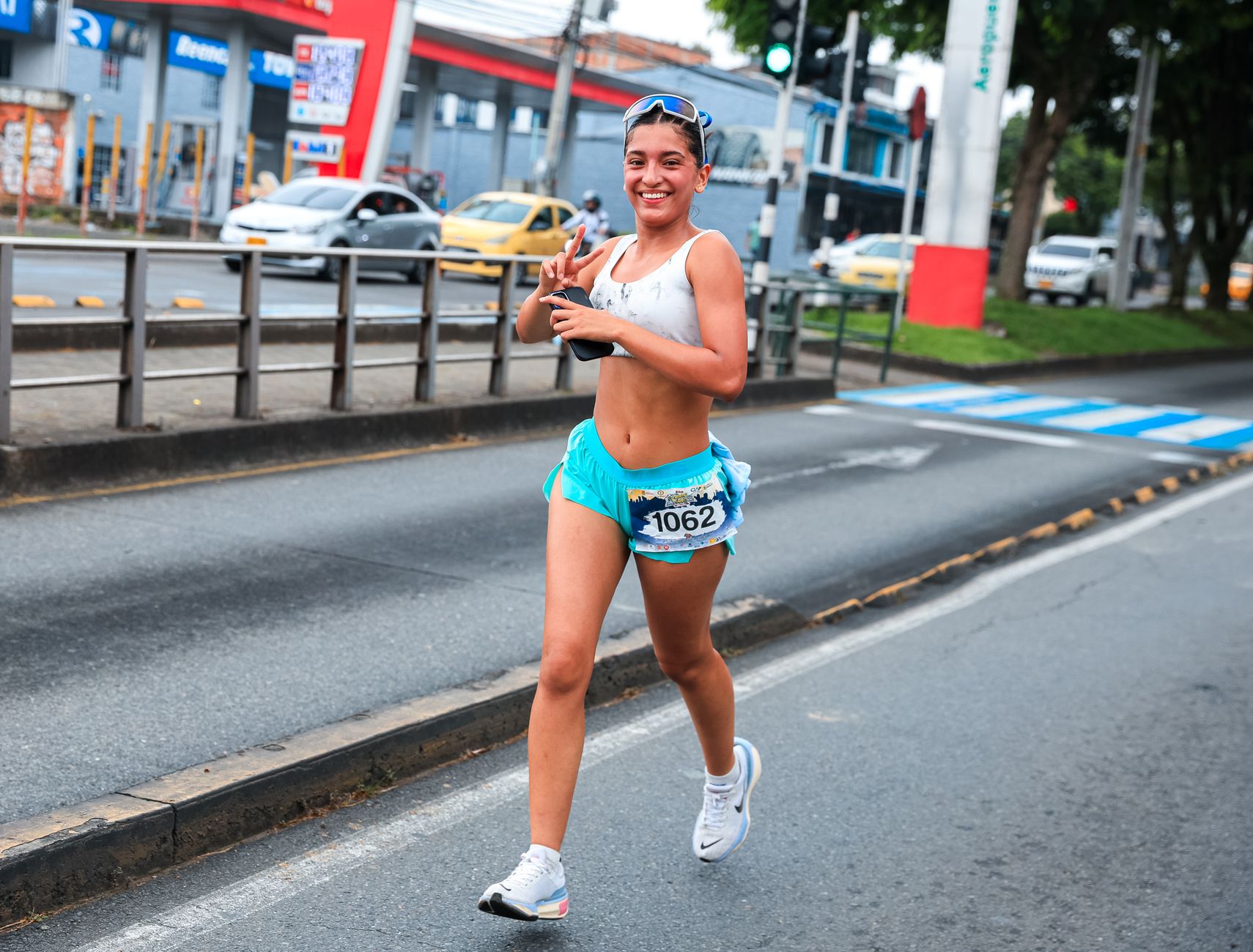 female runner stretching before urban half marathon