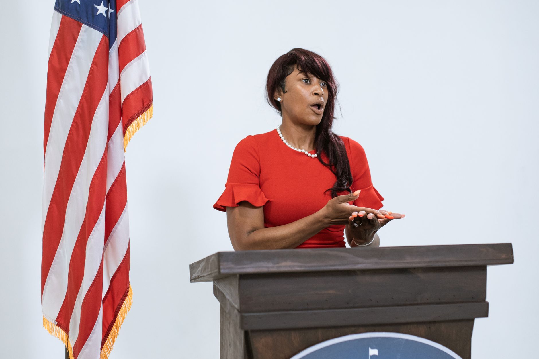 government official speaking at podium microphone press conference