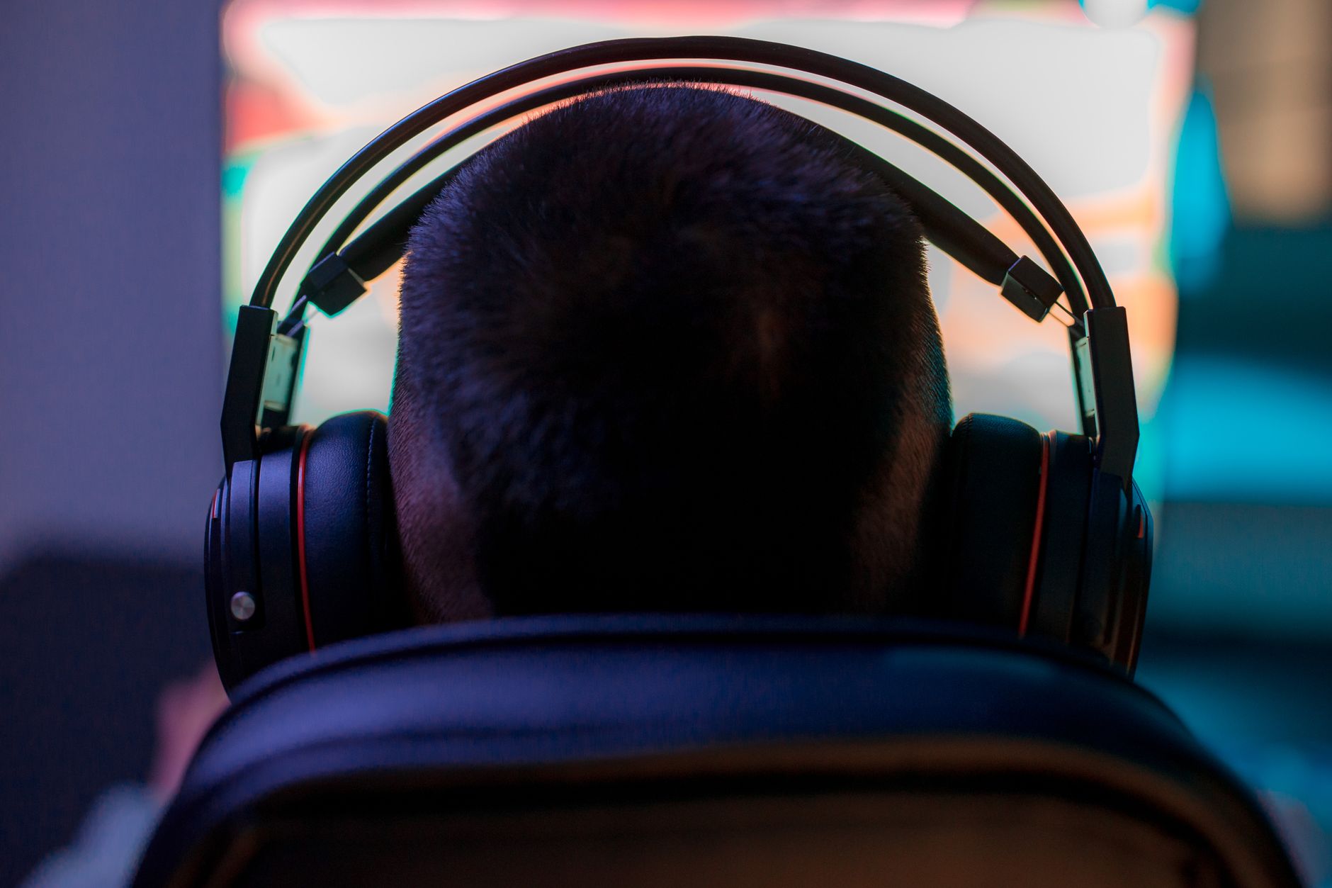 person wearing headset focused on screen playing Free Fire