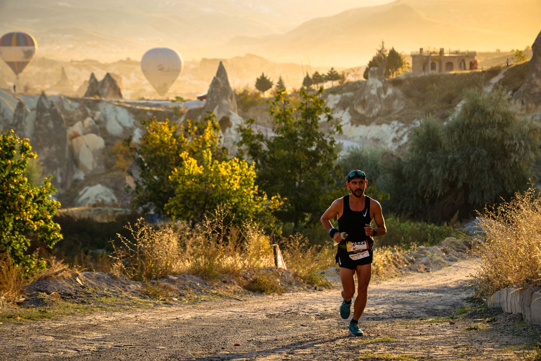 trail runner ascending mountain path sunrise