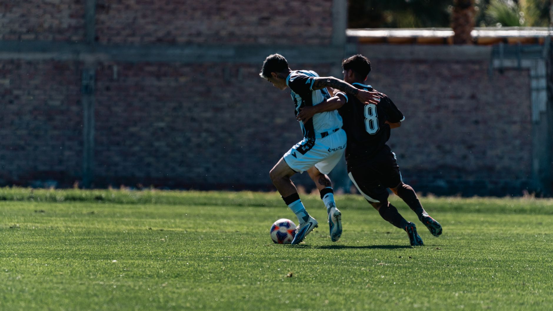 football players competing for ball on field