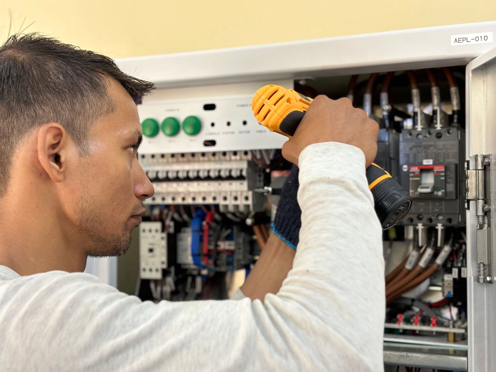 electrician hands connecting wires in fuse box