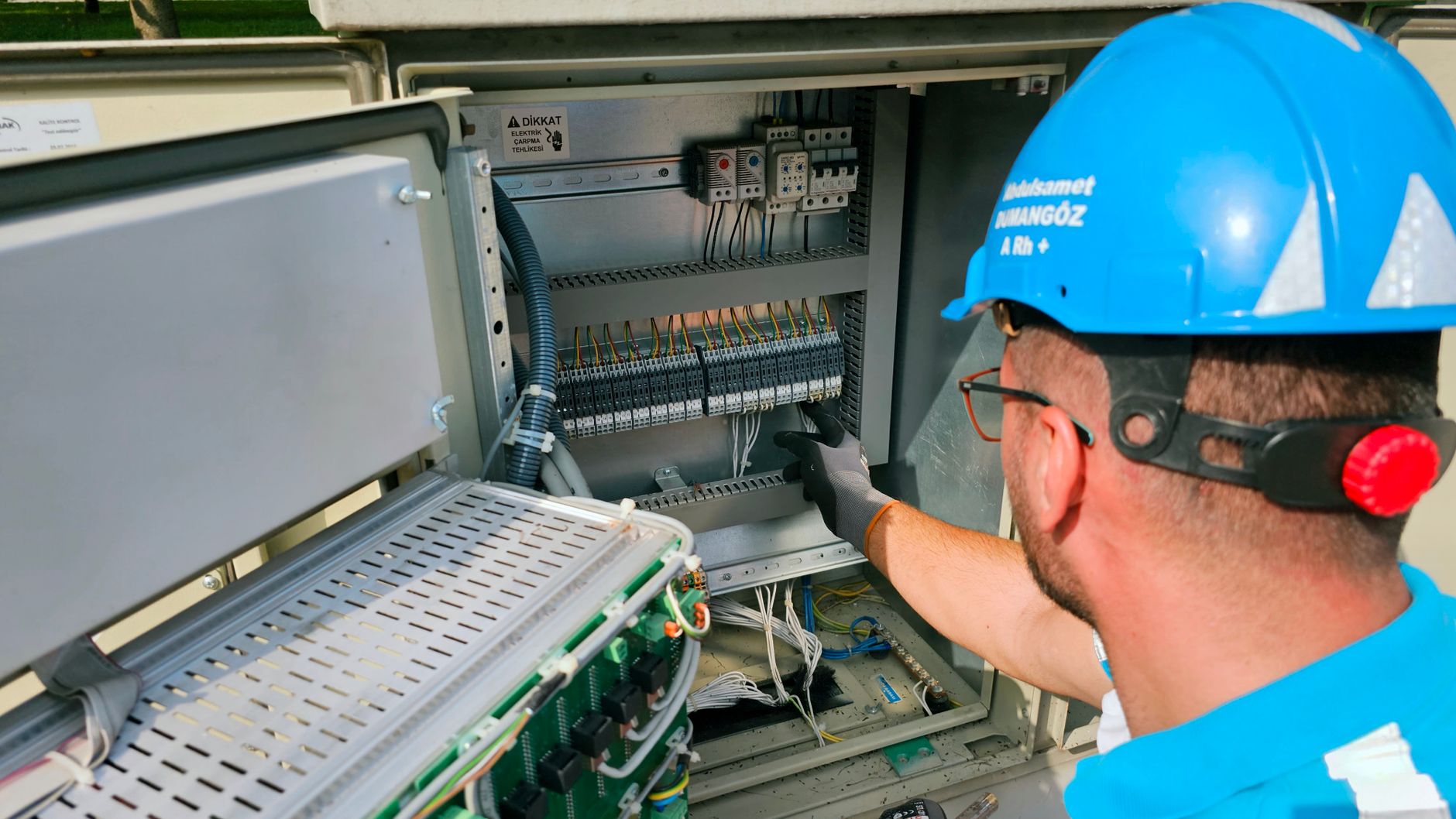 electrician hands connecting wires in fuse box