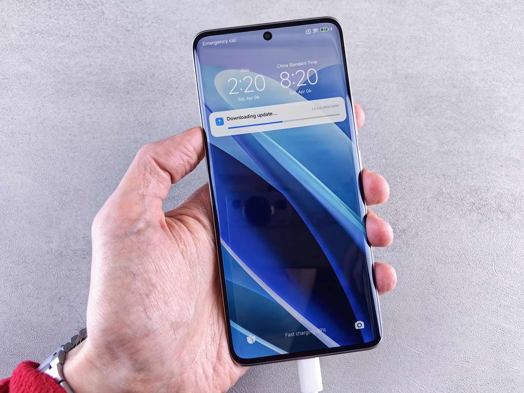 hand holding android phone while charging