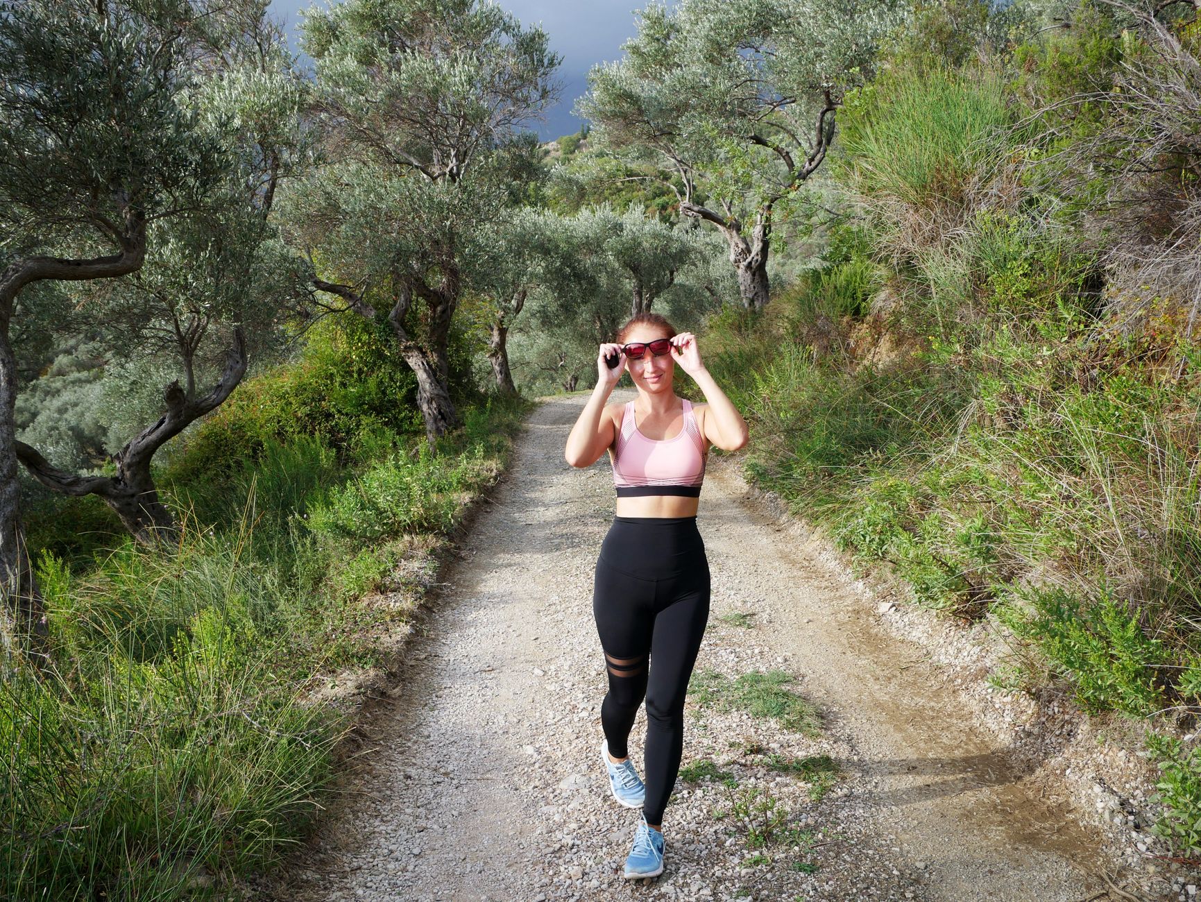 person trail running through forest path morning