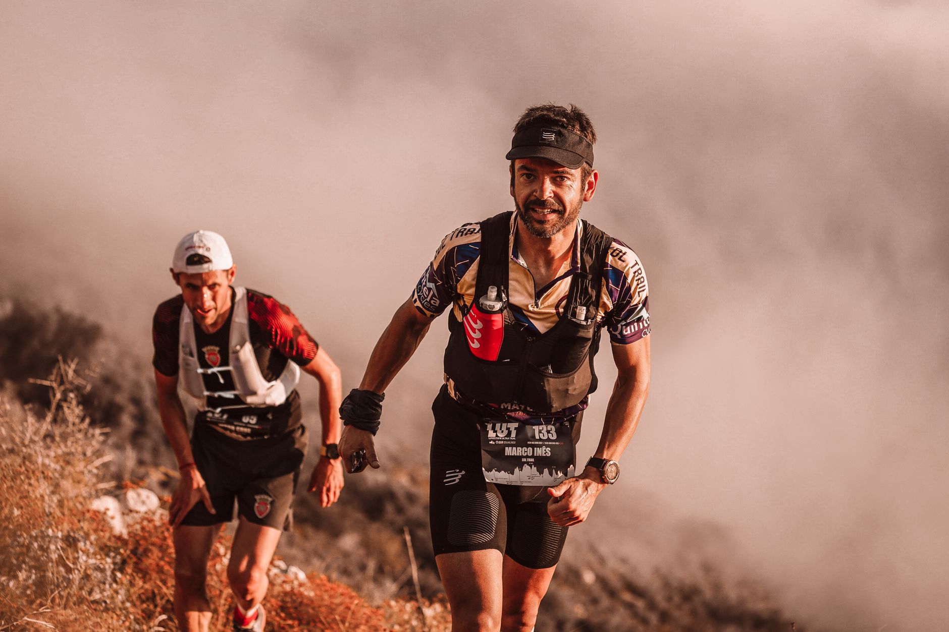 trail runner ascending mountain path with scenic view