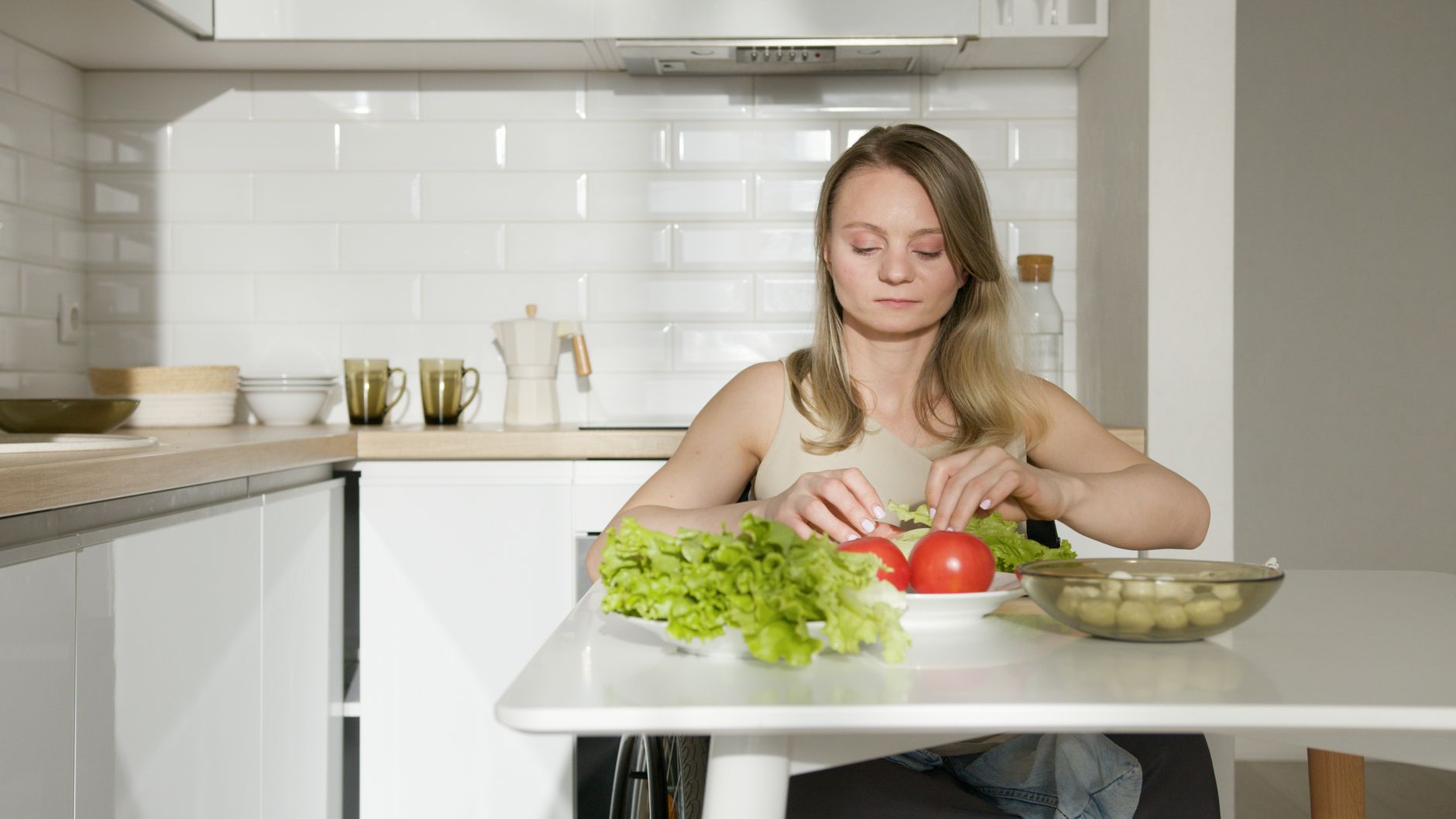 woman preparing fresh salad in kitchen