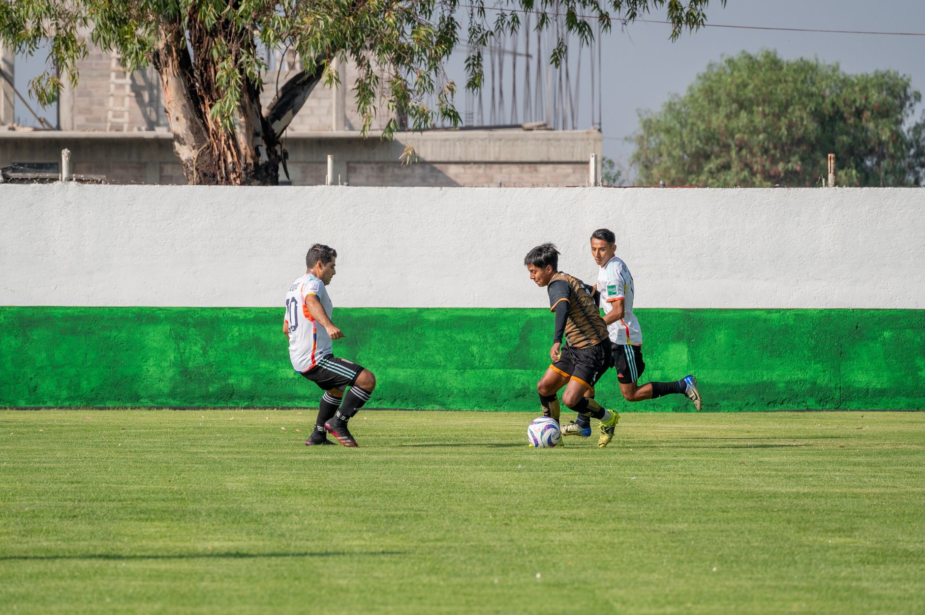 football players competing for ball on field