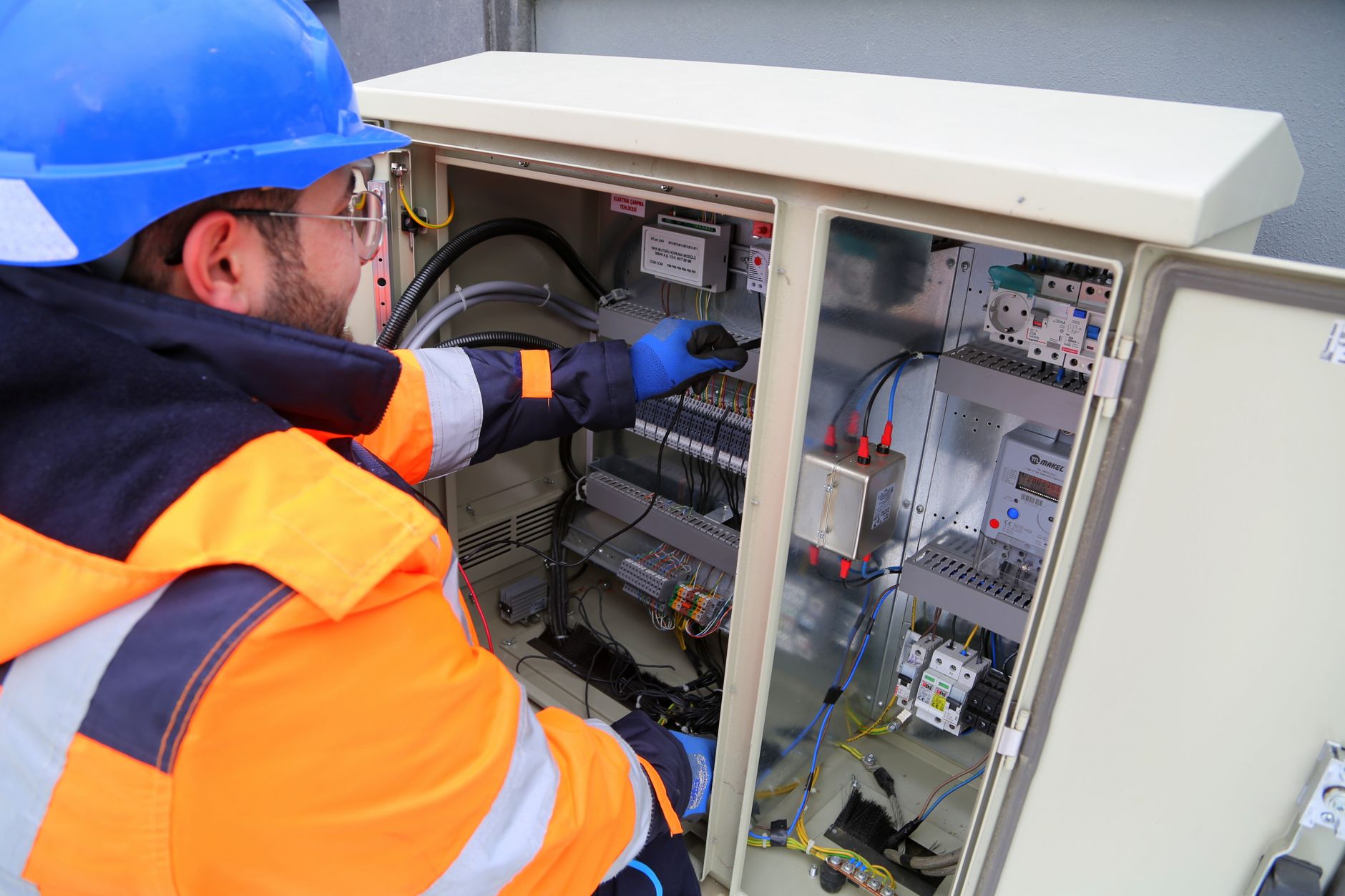electrician hands connecting wires in fuse box