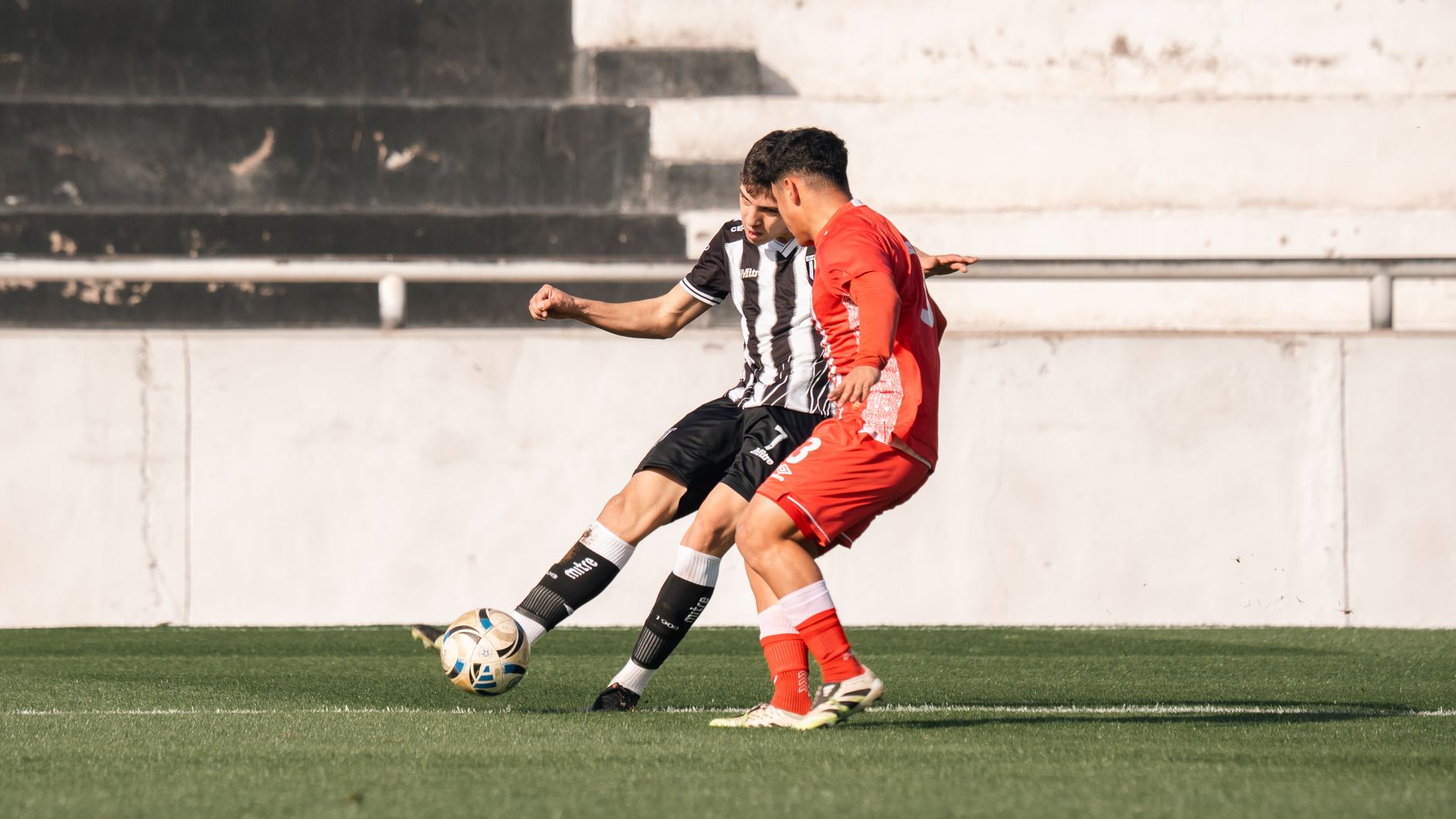 two football players challenging for ball stadium