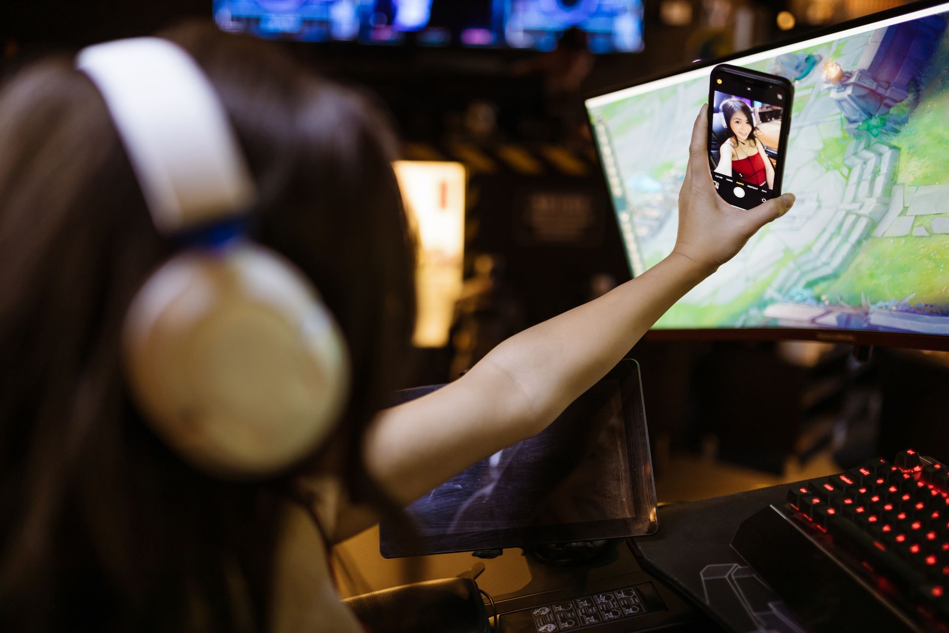 Gamer hands holding smartphone playing mobile game