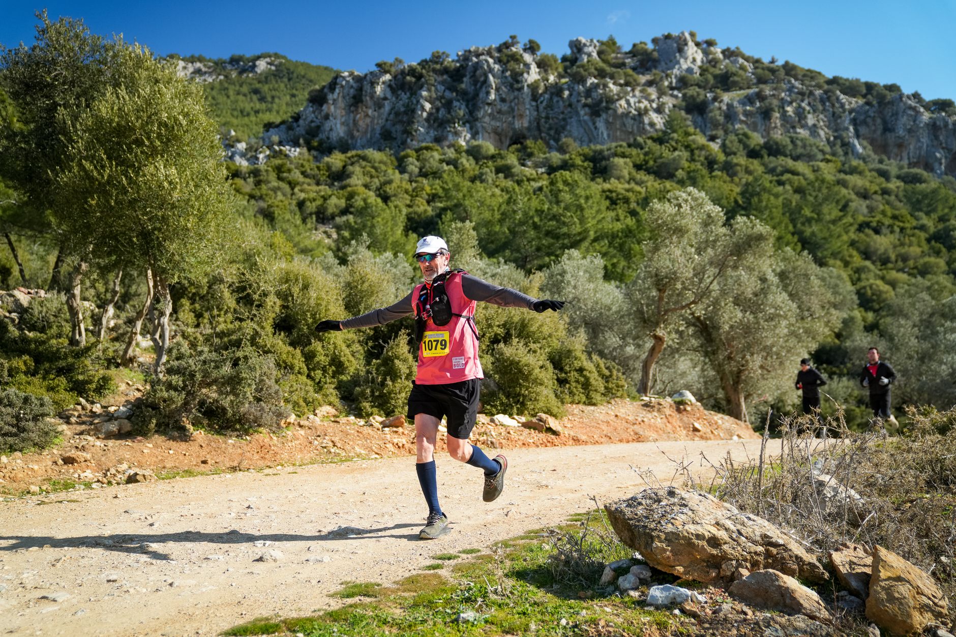 trail runner climbing mountain path sunrise