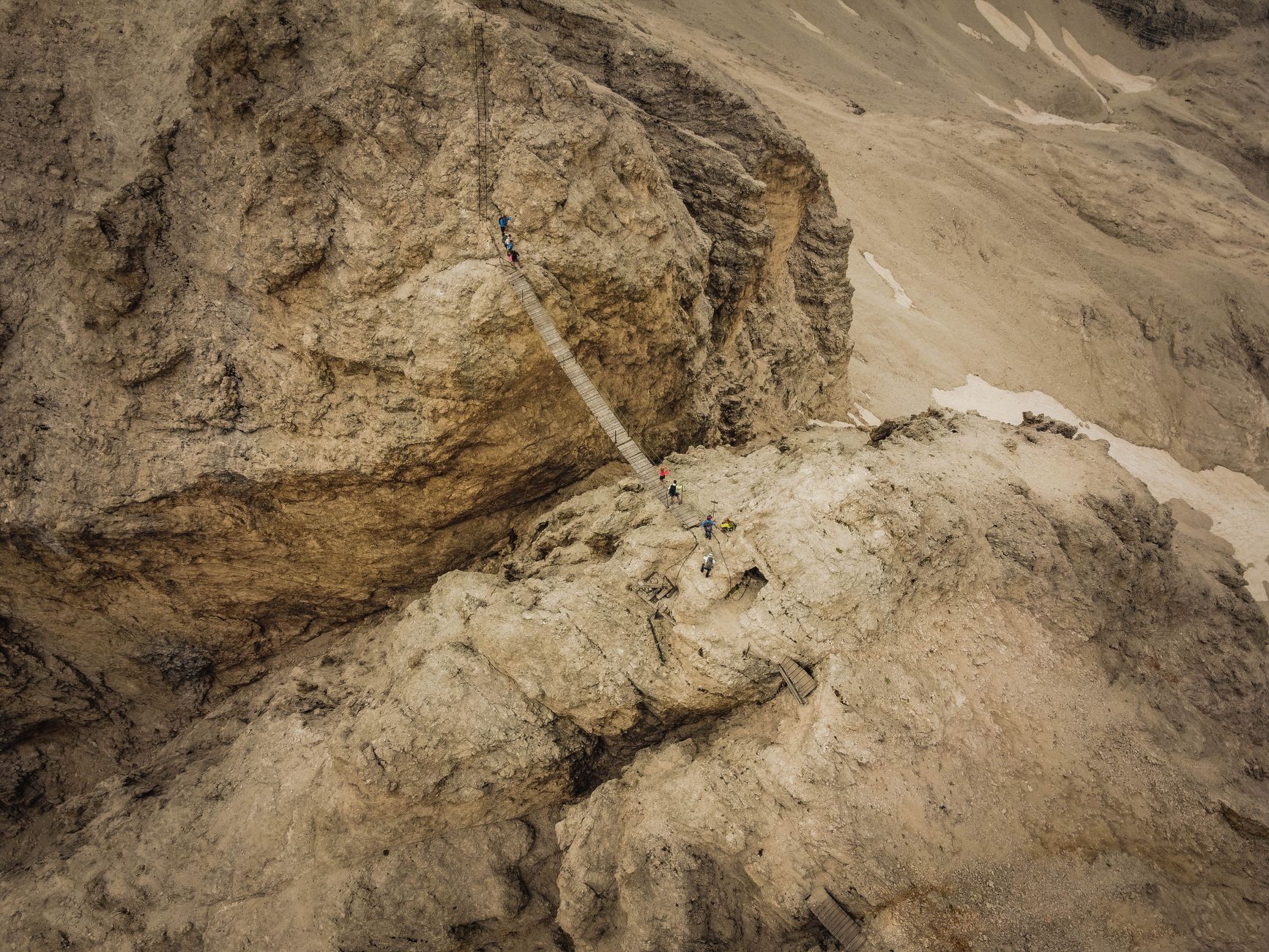 trail runner climbing steep muddy mountain path