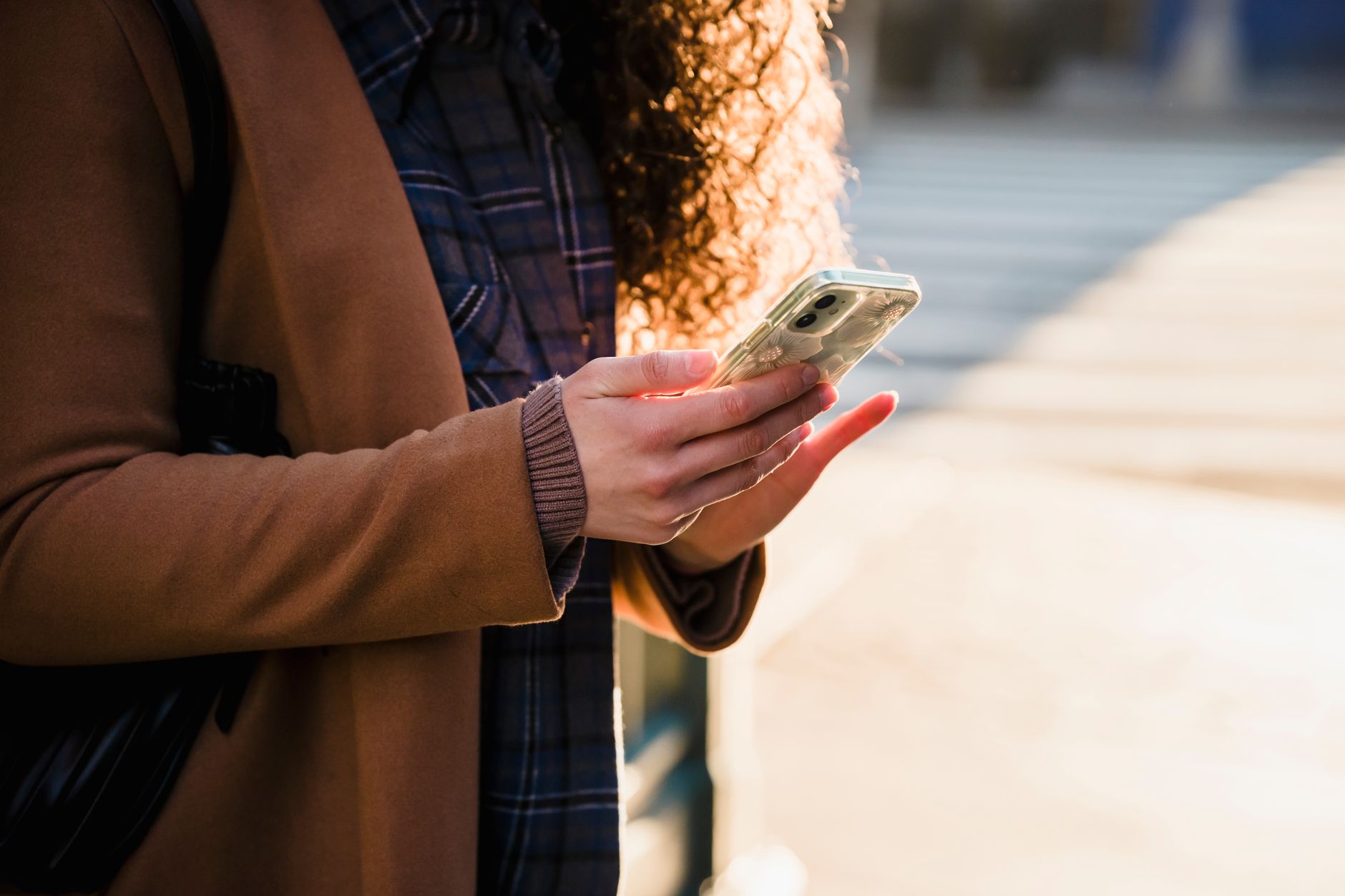 person holding smartphone checking signal bars home