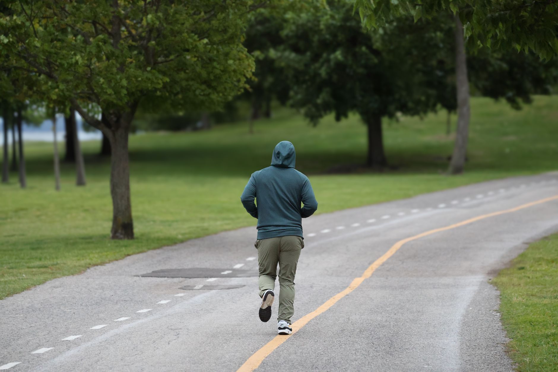 person jogging in green park early morning
