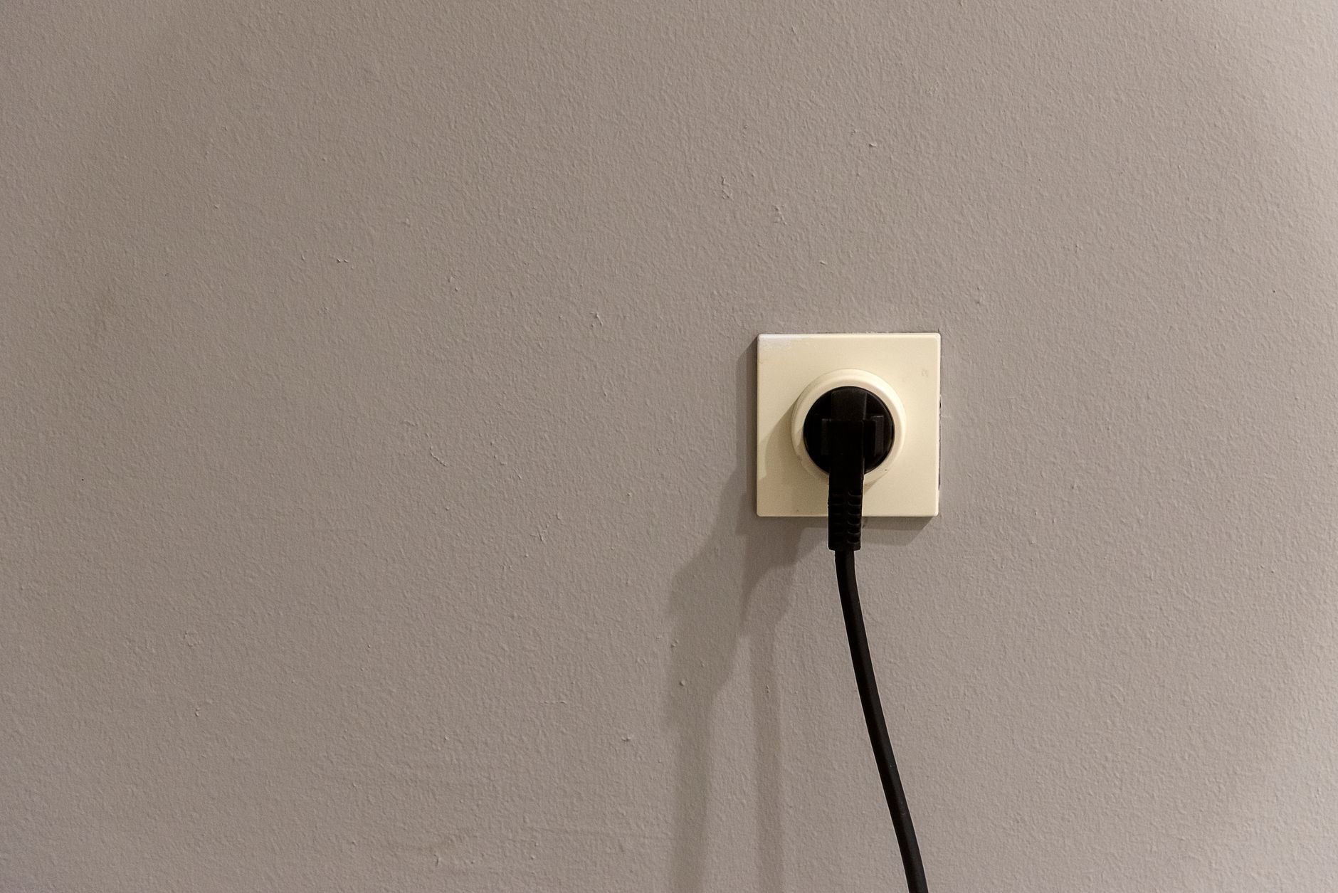power outlet and plug on white wall