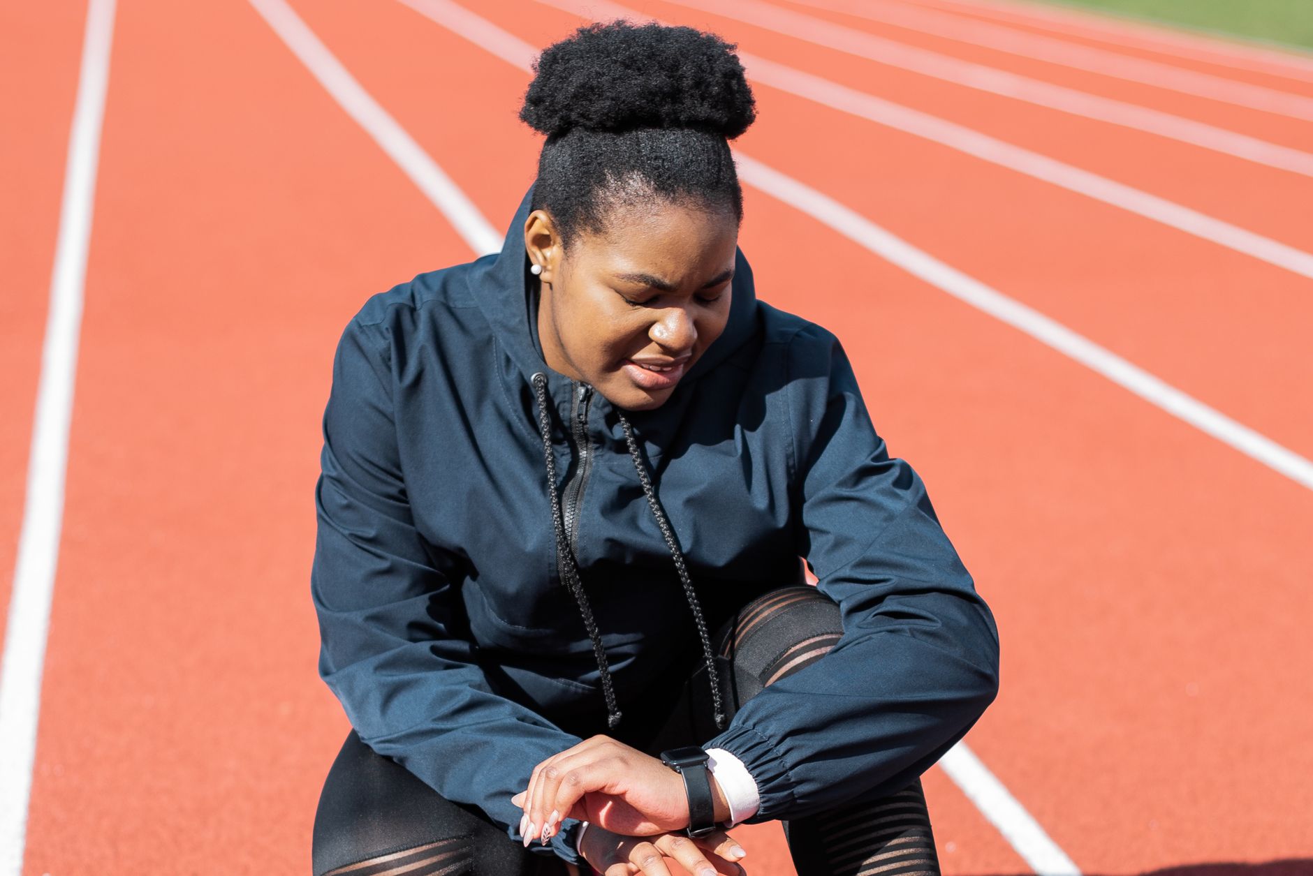 runner checking smartwatch after run city park