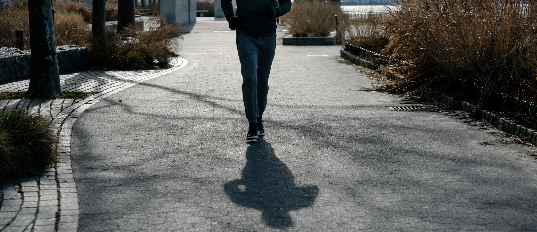 runner checking smartwatch during morning jog