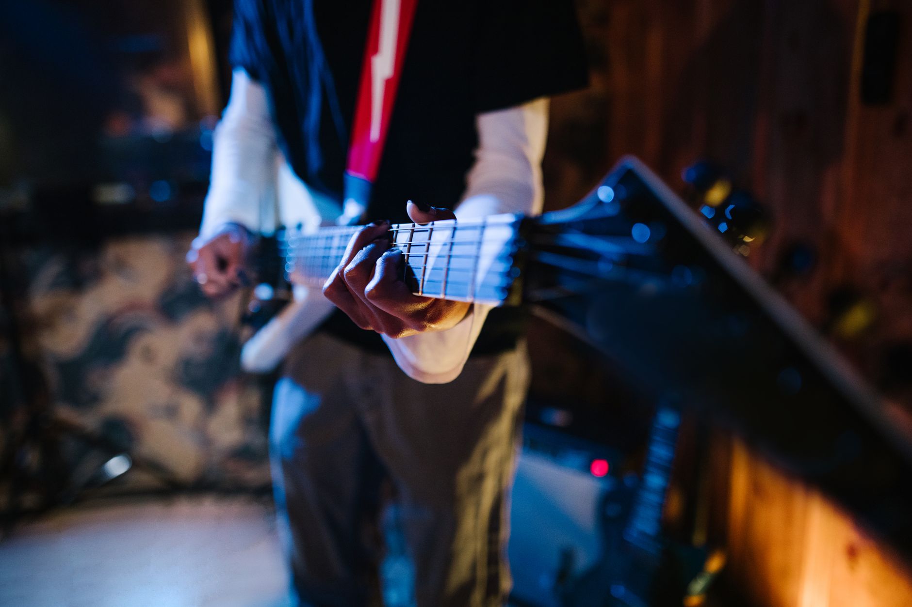 musician playing guitar on stage with lights rock band